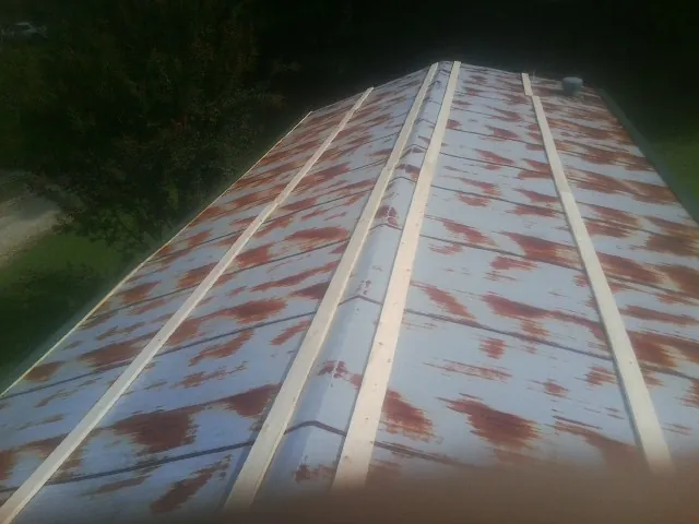 Rusted metal roof panels with new wood purlins before replacement — Storm Damage Roof Repair in Marsing by Roofing Brothers